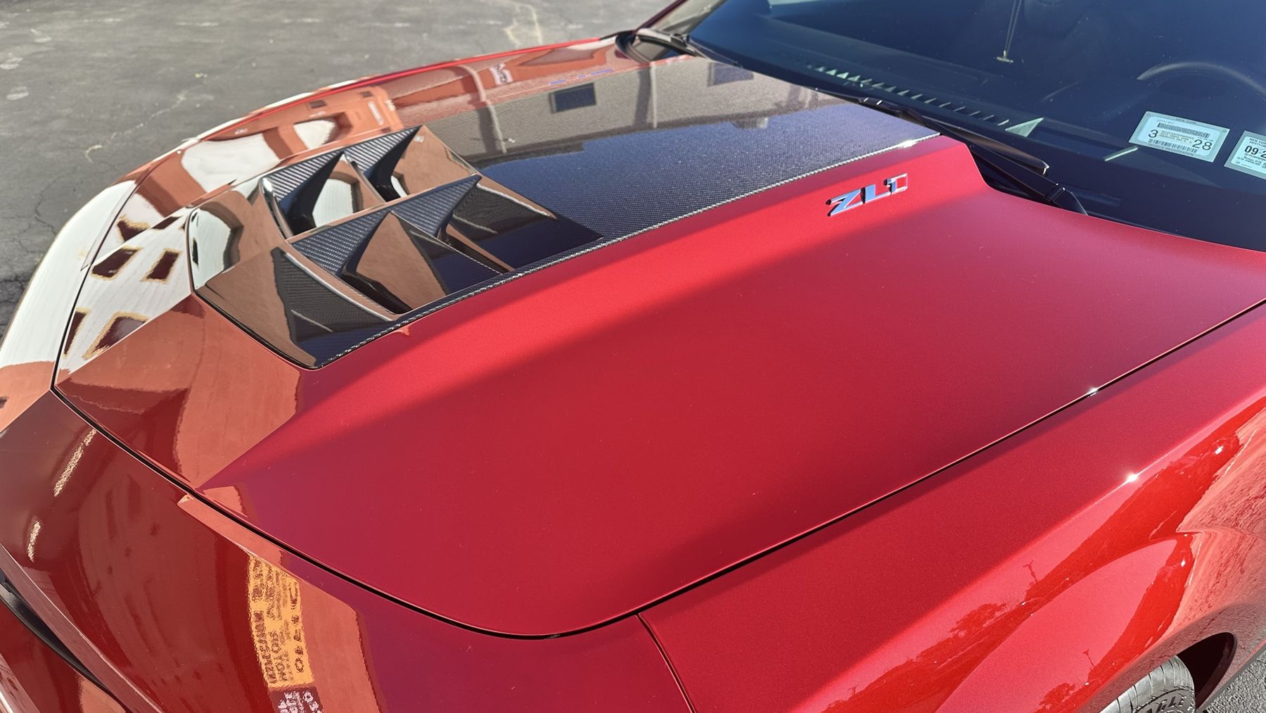 Ceramic-coated red Camaro ZL1 hood with deep gloss and crisp reflections