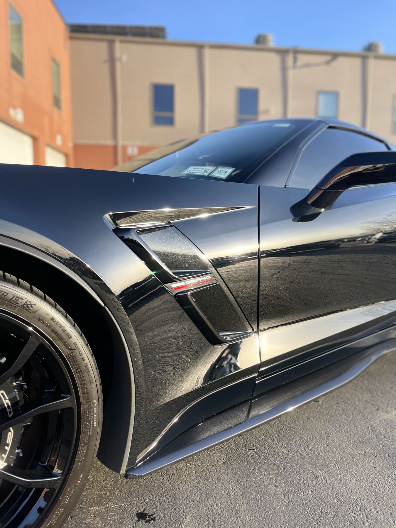 Black Corvette Grand Sport fender with mirror-like reflections