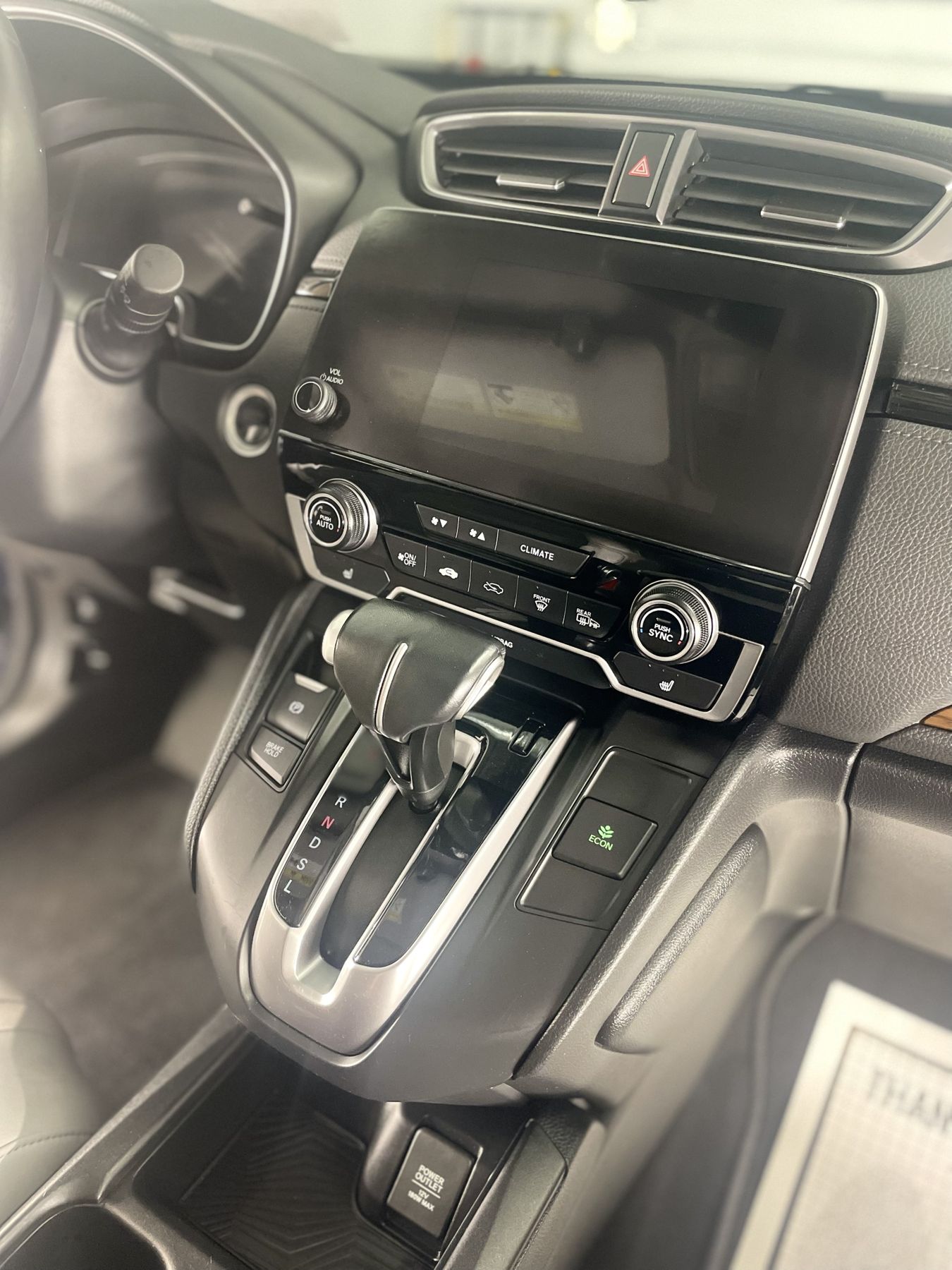 The same Honda CR-V console clean and glossy after an interior detail