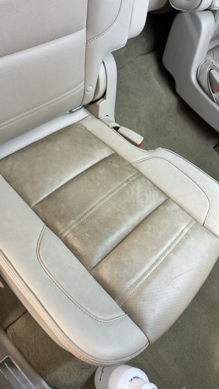 Light leather seat with dirt and grime worn into the cushions before cleaning
